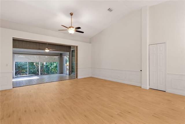 empty room featuring light hardwood / wood-style floors, vaulted ceiling, and ceiling fan