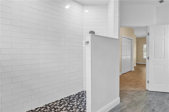 bathroom with tiled shower