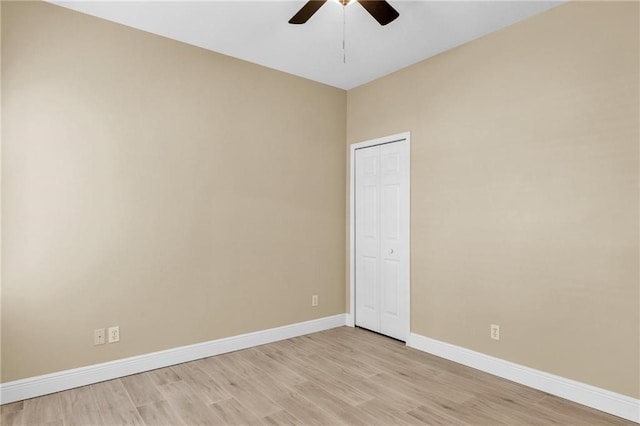 empty room with ceiling fan and light wood-type flooring