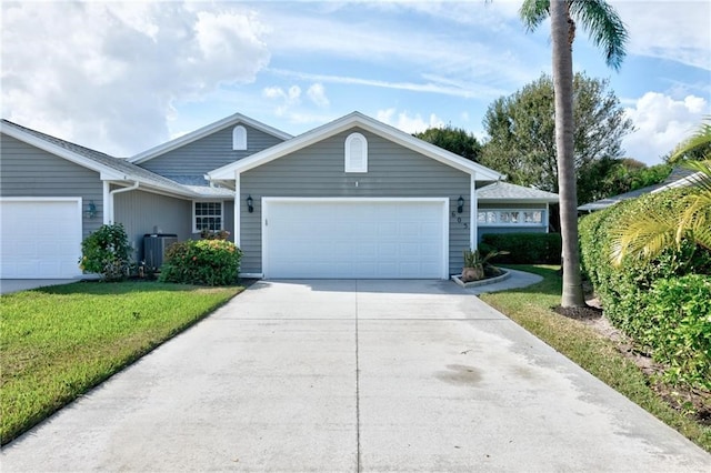 ranch-style home featuring a garage, central air condition unit, and a front lawn