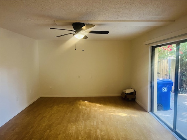 spare room featuring ceiling fan, light hardwood / wood-style flooring, and a textured ceiling