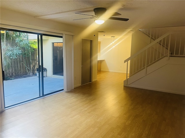 spare room featuring wood-type flooring, a textured ceiling, and ceiling fan