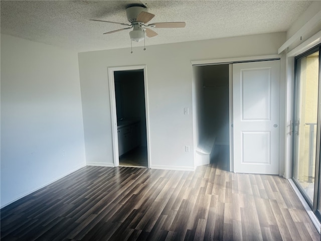 unfurnished bedroom featuring hardwood / wood-style flooring, ceiling fan, multiple windows, and a closet