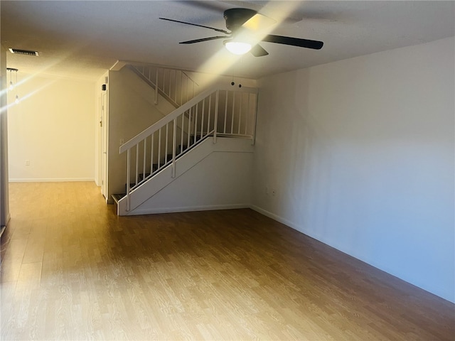 interior space with ceiling fan and wood-type flooring