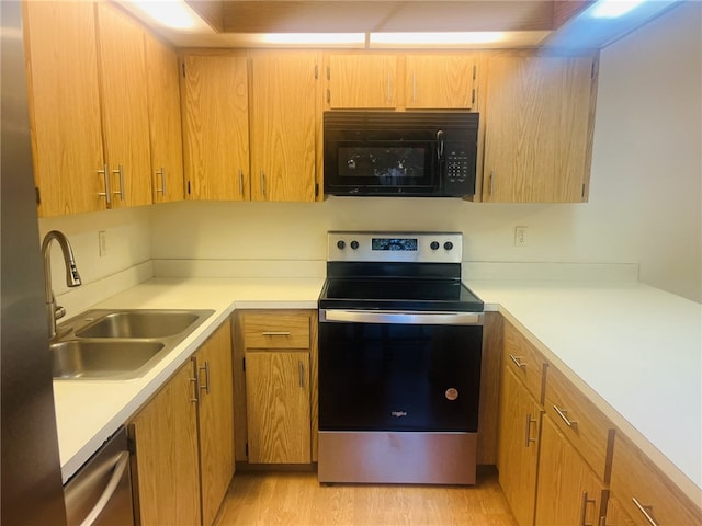 kitchen featuring light hardwood / wood-style floors, sink, and stainless steel appliances