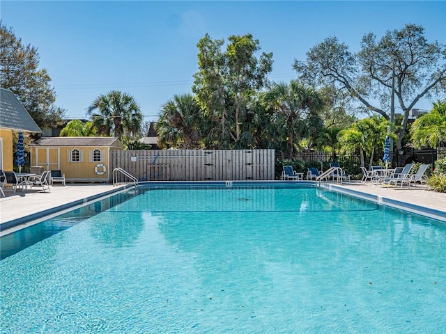 view of pool featuring a patio and an outdoor structure