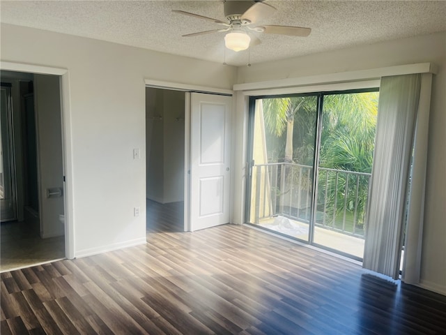 unfurnished bedroom featuring access to exterior, a textured ceiling, ceiling fan, wood-type flooring, and a closet