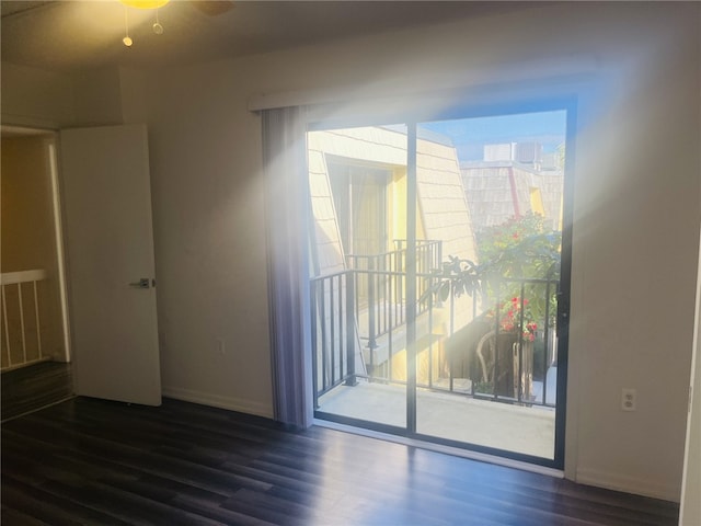 unfurnished room with dark wood-type flooring