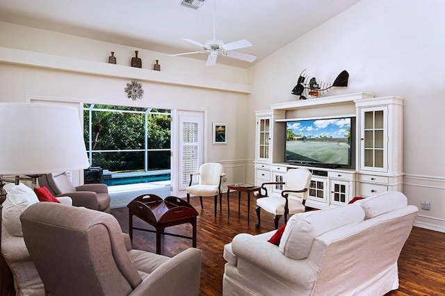 living room with ceiling fan, dark wood-type flooring, and high vaulted ceiling