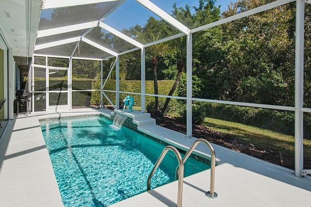 view of swimming pool with glass enclosure, pool water feature, a patio, and grilling area