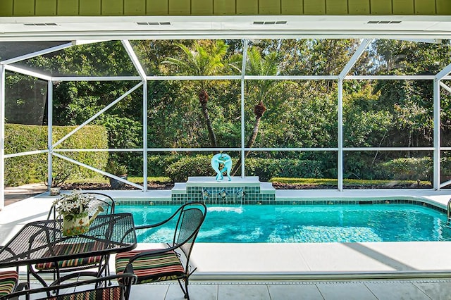 view of pool featuring glass enclosure and a patio area