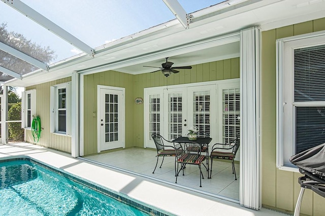 exterior space featuring ceiling fan, a pool, and french doors