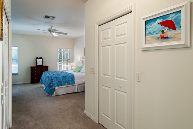 bedroom with ceiling fan, carpet floors, and a closet