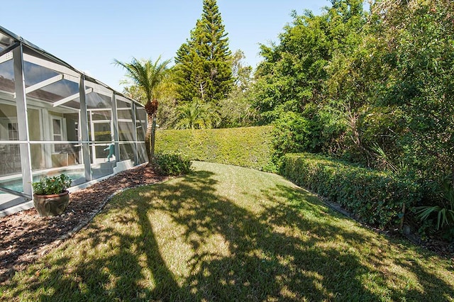 view of yard with glass enclosure