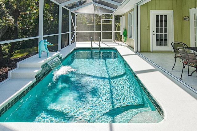 view of pool with a lanai, pool water feature, and a patio