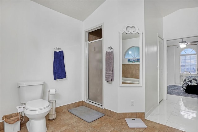 bathroom featuring lofted ceiling, a shower with door, ceiling fan, tile patterned floors, and toilet