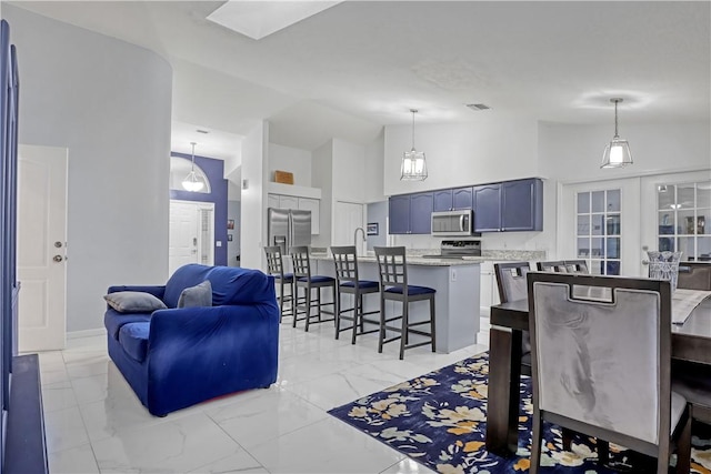 living room with sink, high vaulted ceiling, and french doors