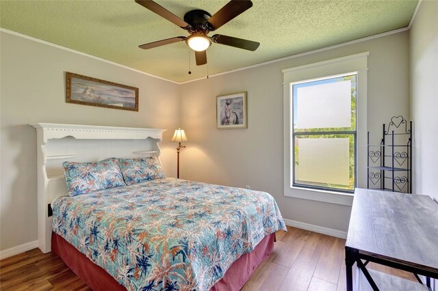 1805 15th St SW, Vero Beach, FL 32962 - bedroom with baseboards, ornamental molding, a textured ceiling, and wood finished floors