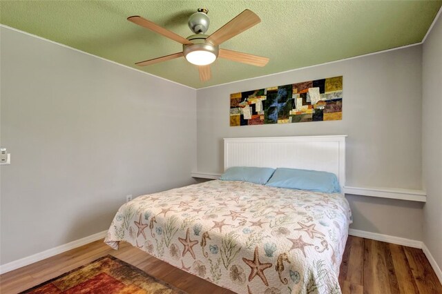 1805 15th St SW, Vero Beach, FL 32962 - bedroom with ceiling fan, a textured ceiling, baseboards, and wood finished floors