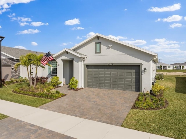 ranch-style house featuring a garage, a front yard, decorative driveway, and stucco siding