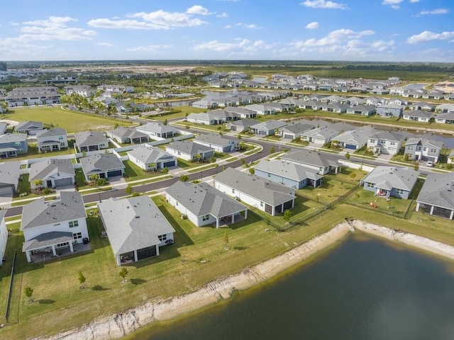 drone / aerial view featuring a water view and a residential view