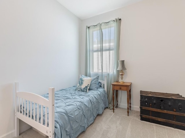 carpeted bedroom featuring vaulted ceiling and baseboards