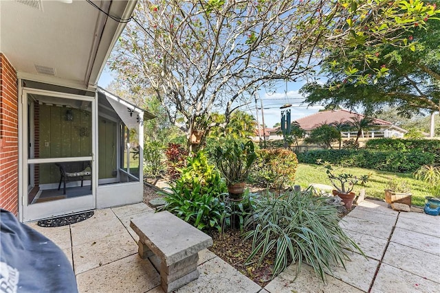 view of patio featuring a sunroom