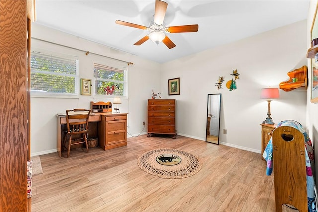 home office featuring ceiling fan and light hardwood / wood-style flooring