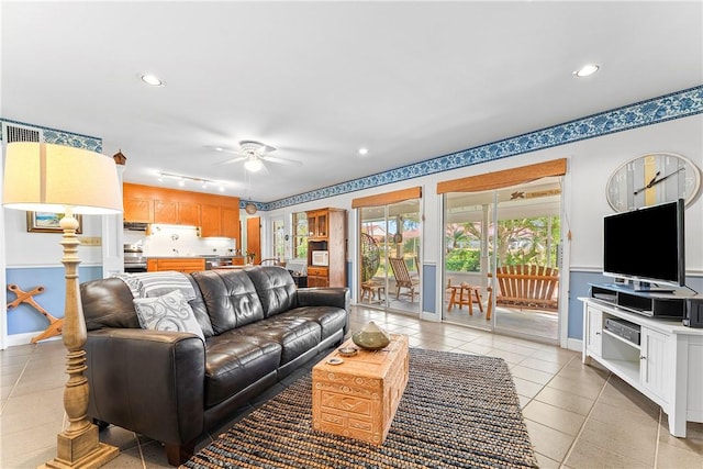 living room featuring ceiling fan and light tile patterned flooring