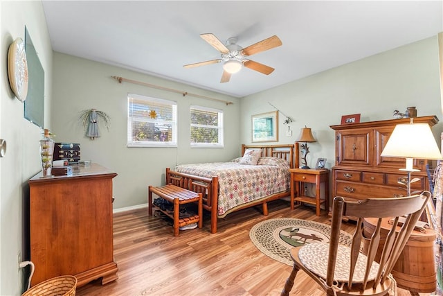 bedroom with ceiling fan and light hardwood / wood-style floors