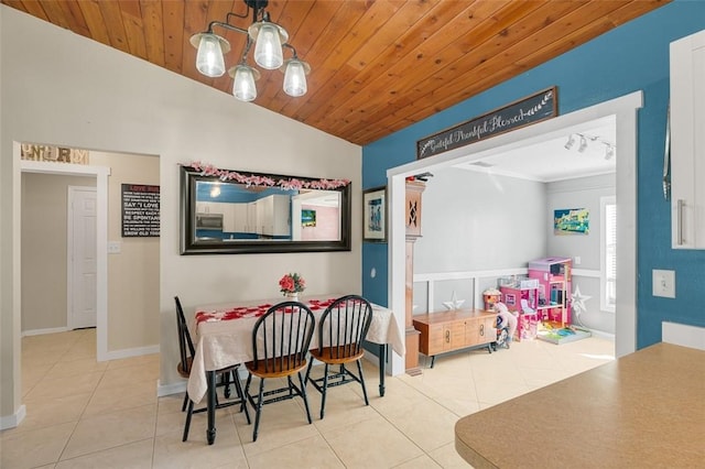 tiled dining room with lofted ceiling, wooden ceiling, and an inviting chandelier