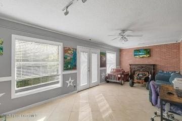 1440 16th Ct SW, Vero Beach, FL 32962 - living room featuring healthy amount of natural light, ceiling fan, french doors, and ornamental molding