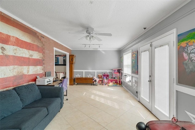 living room featuring crown molding, a textured ceiling, light tile patterned floors, track lighting, and ceiling fan