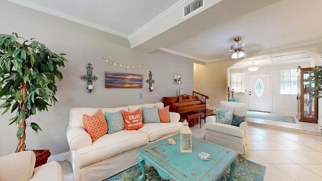 living room with ornamental molding, light tile patterned floors, and ceiling fan