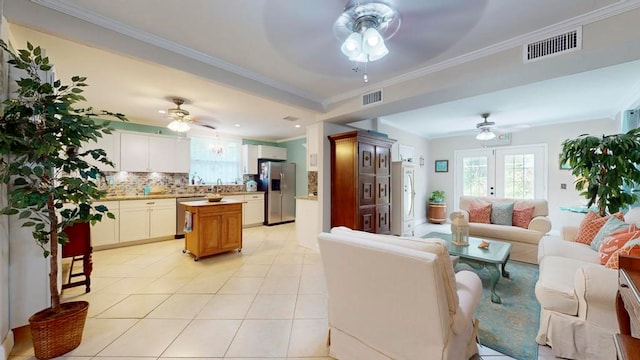 tiled living room with ceiling fan, french doors, and ornamental molding