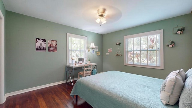 bedroom with dark hardwood / wood-style flooring and ceiling fan