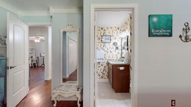 hall featuring ornamental molding, sink, and light hardwood / wood-style floors