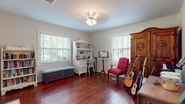 sitting room featuring ceiling fan, a healthy amount of sunlight, and dark hardwood / wood-style flooring