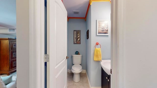 bathroom with ornamental molding, tile patterned flooring, vanity, and toilet