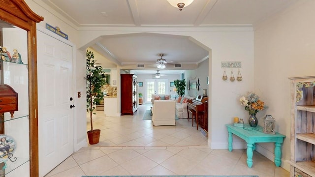 corridor with light tile patterned floors and ornamental molding