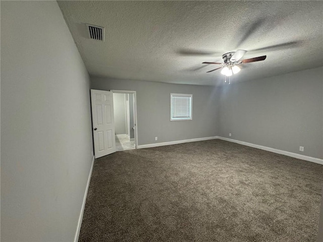 unfurnished room featuring a ceiling fan, visible vents, baseboards, and dark colored carpet