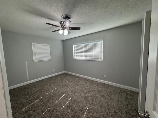 carpeted spare room with visible vents, baseboards, a textured ceiling, and ceiling fan