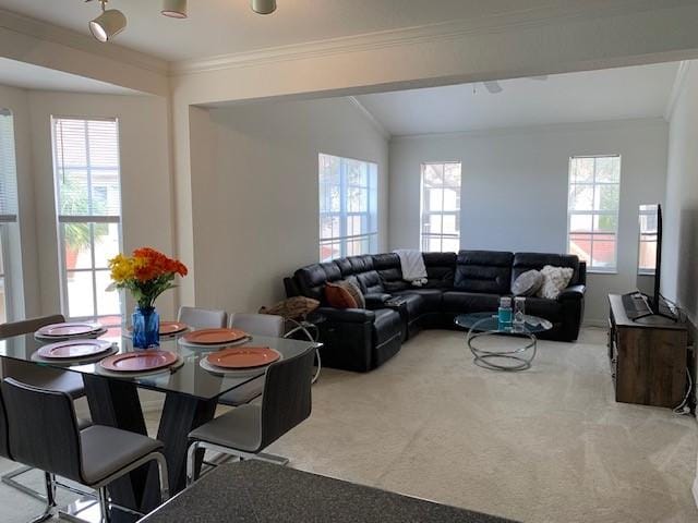 living room with crown molding, vaulted ceiling, and light colored carpet