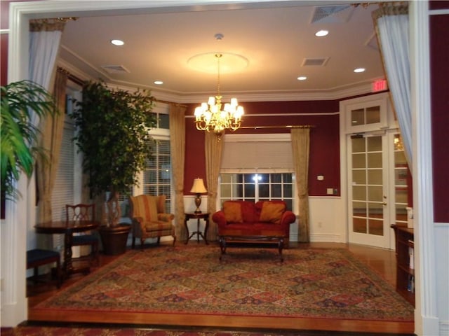 sitting room featuring ornamental molding and a notable chandelier