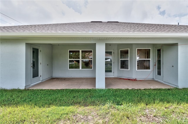 rear view of property with a patio and a yard