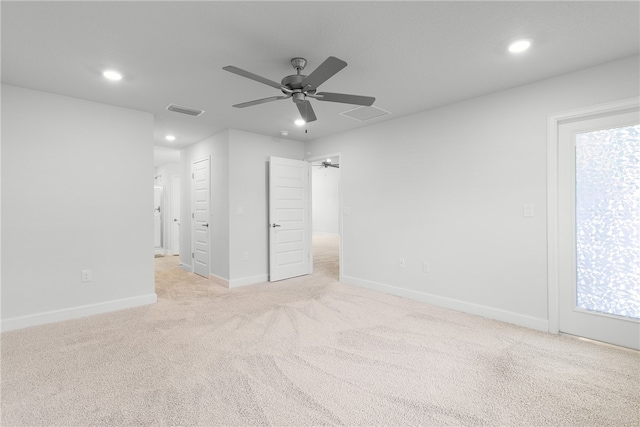 unfurnished bedroom with ceiling fan, multiple windows, and light carpet