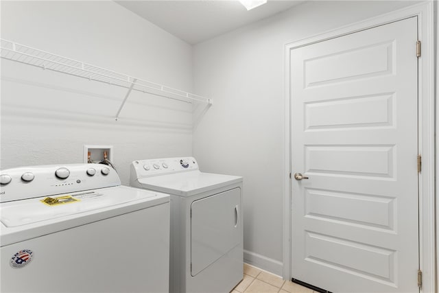 laundry area with light tile patterned flooring and independent washer and dryer