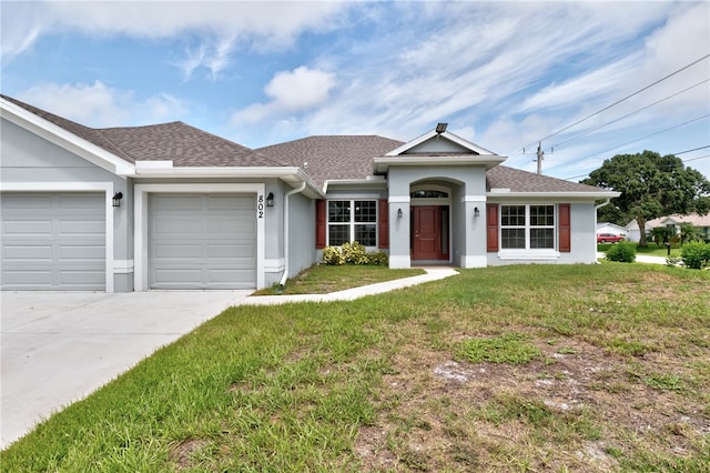 ranch-style house featuring a garage and a front lawn