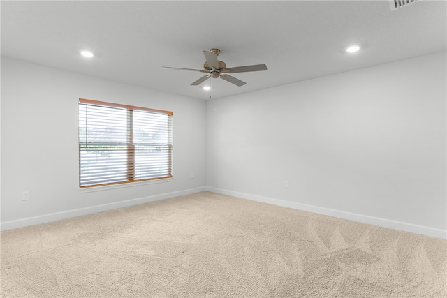 carpeted spare room with ceiling fan