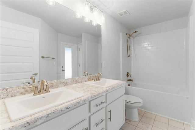 full bathroom with a textured ceiling, tile patterned floors, vanity, shower / washtub combination, and toilet